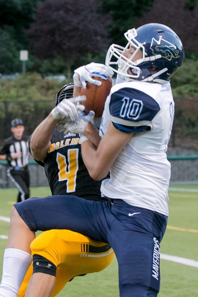 Meadowdale’s Colton Walsh (right) makes a touchdown reception with Inglemoor’s KIncaid Schmitt (left) defending Thursday night at Pop Kenney Stadium in Bothell on August 30, 2018. (Kevin Clark / The Herald)
