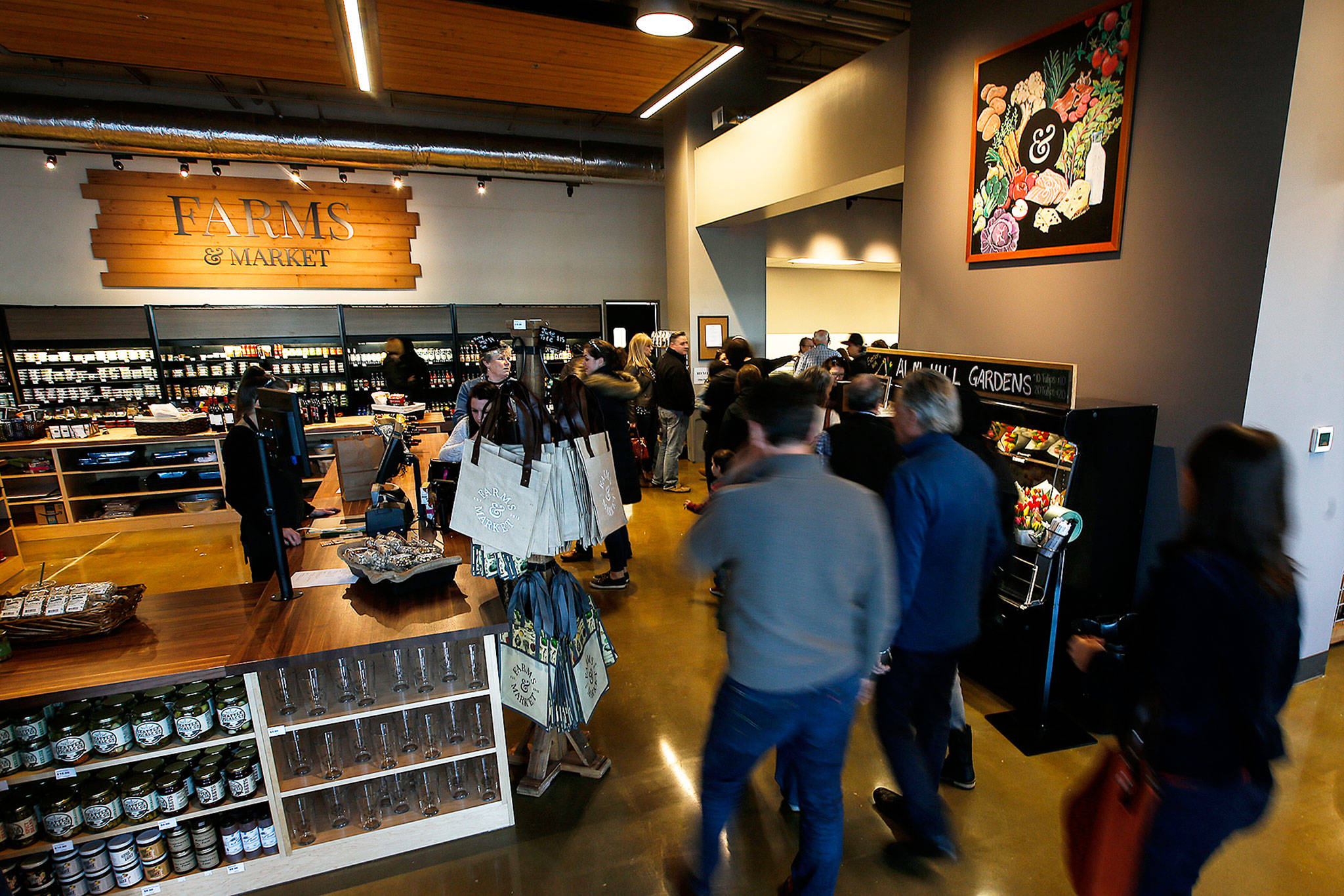 Customers stream into Farms & Market in Everett during the business’s grand opening celebration March 1. (Herald file)