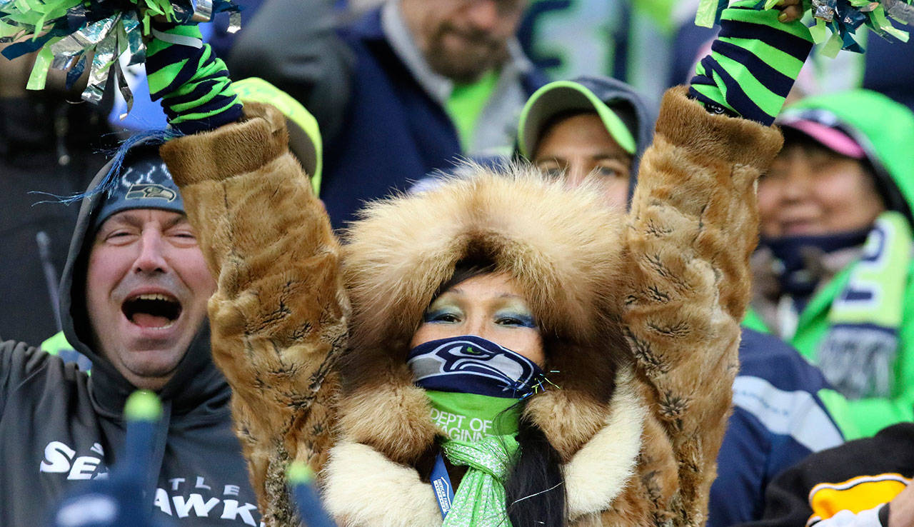 Seahawks fans celebrate at CenturyLink Field during a game against the Pittsburgh Steelers in November of 2015. (Kevin Clark / The Herald)