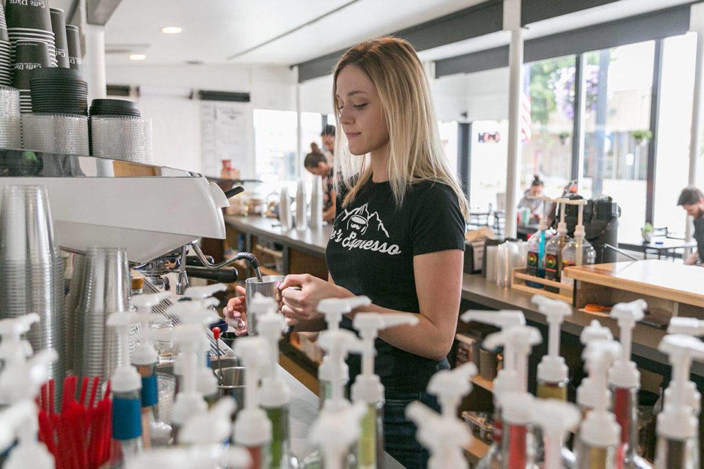 Katie Anderson prepares a coffee order Friday morning at Moe’s Espresso in downtown Arlington on August 24, 2018. (Kevin Clark / The Herald)
