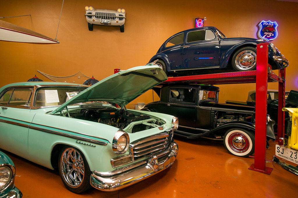 At Bobo’s Rods and Customs, a 1960 VW Beetle perches above a 1931 Plymouth; and at left front is a 1956 Chrysler Windsor Newport, just a few of the many classic cars currently for sale. Prices range from $12,000 to as much as $100,000. (Andy Bronson / The Herald)

