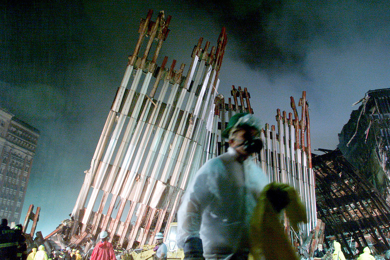 The facade of one of the towers of the World Trade Center lies in ruins as workmen work in the early morning hours on Sept. 14, 2001. (Gary Friedman / Los Angeles Times)