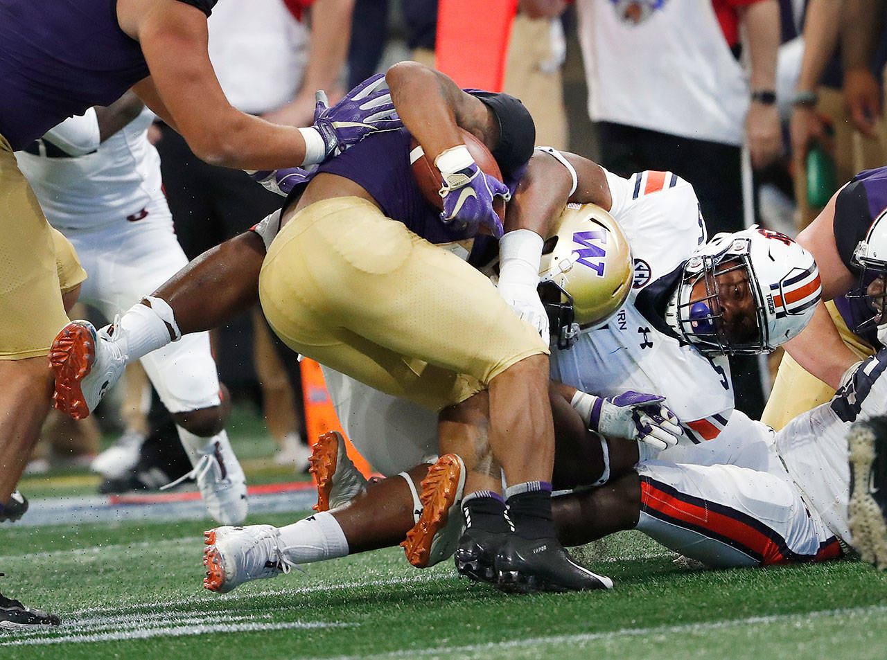 Washington running back Myles Gaskin (9) is stopped by Auburn defensive lineman Derrick Brown (5) in the first half of a game Sept. 1, 2018, in Atlanta. (AP Photo/John Bazemore)