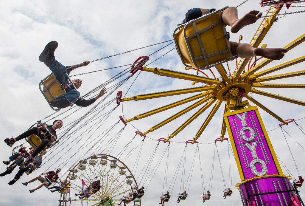People enjoy the Yoyo ride on opening day of the Evergreen State Fair on Aug. 23, 2018 in Monroe, Wa. (Olivia Vanni / The Herald)