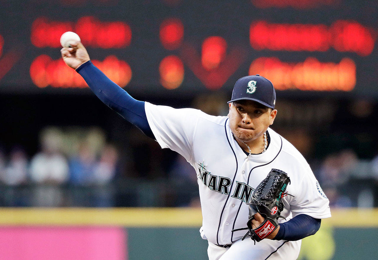 Mariners starting pitcher Erasmo Ramirez throws against the Baltimore Orioles during an MLB game Monday in Seattle. (Elaine Thompson / Associated Press)