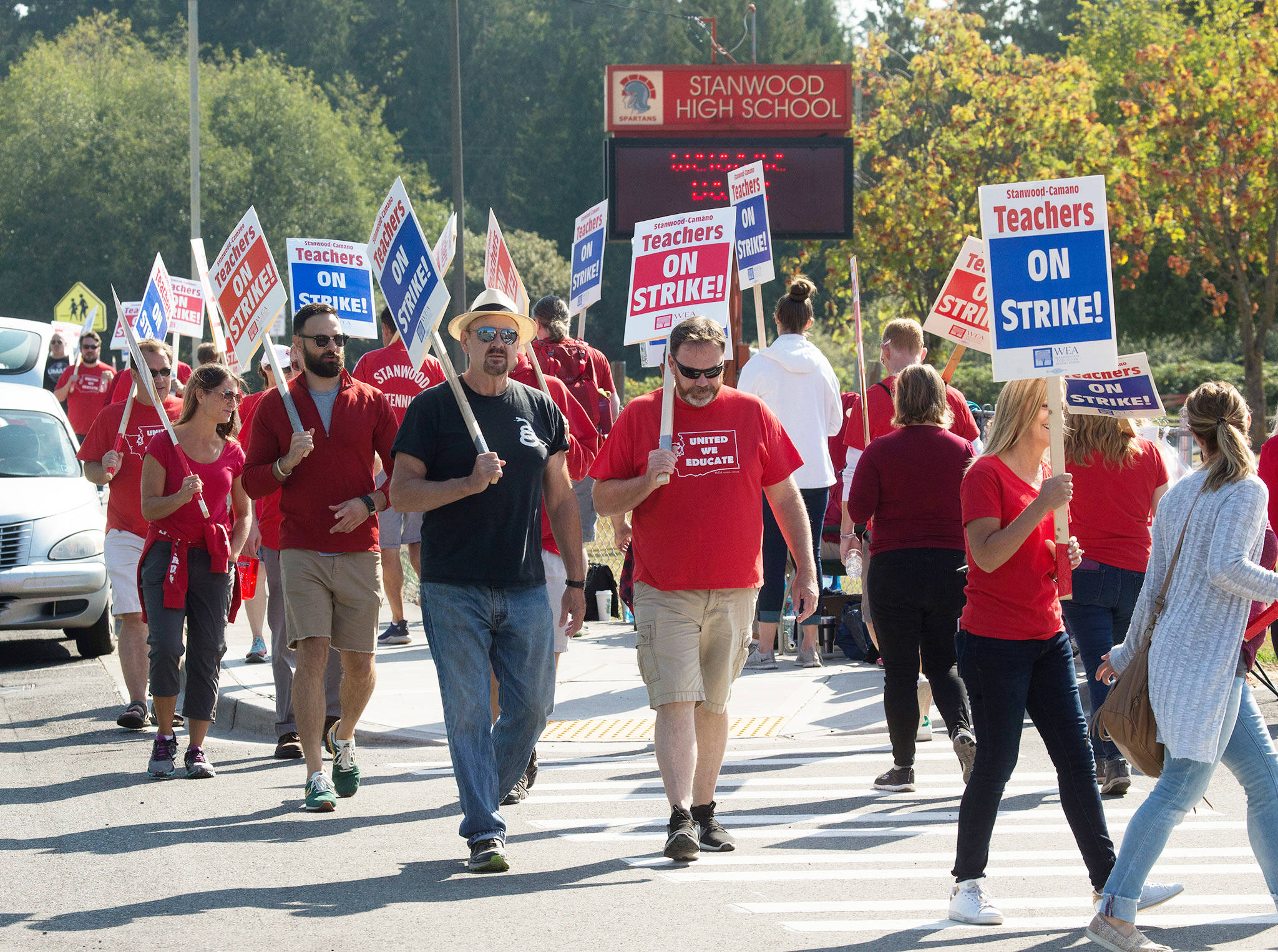 An electronic sign welcomes back students as Stanwood teachers picket in front of the high school on Tuesday in Stanwood. (Andy Bronson / The Herald)