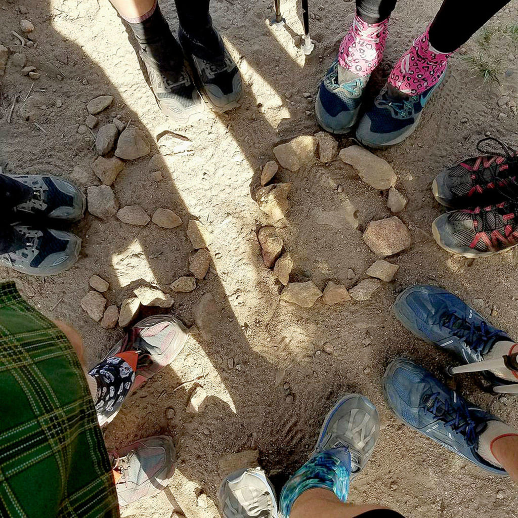 Devin Boyd’s feet are at the bottom of this photo, taken with other hikers at mile marker 50. (Photo Devin Boyd)
