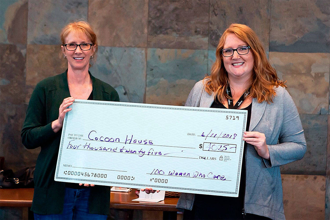 Terri Inglis, of 100+ Women Who Care of South Snohomish County (left), presents a $4,000 donation to Chelsea Monroe of Cocoon House. (Contributed photo)