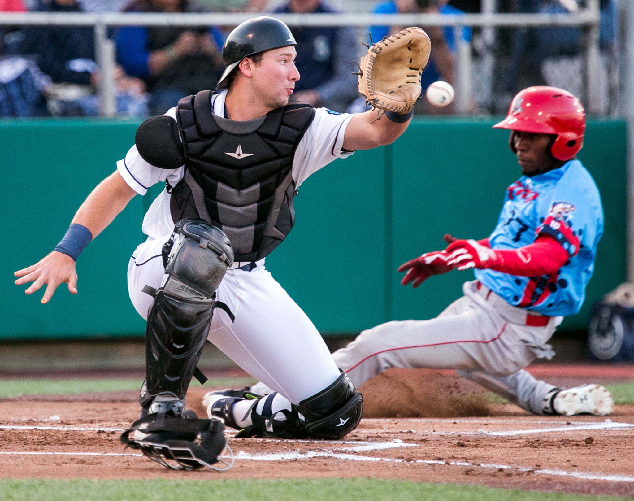 Spokane’s J.P. Martinez beats the throw to AquaSox catcher Cal Raleigh for a run in the first inning of Game 1 of the Northwest League North Division Championship Series on Sept. 5, 2018, at Everett Memorial Stadium . (Kevin Clark / The Herald)