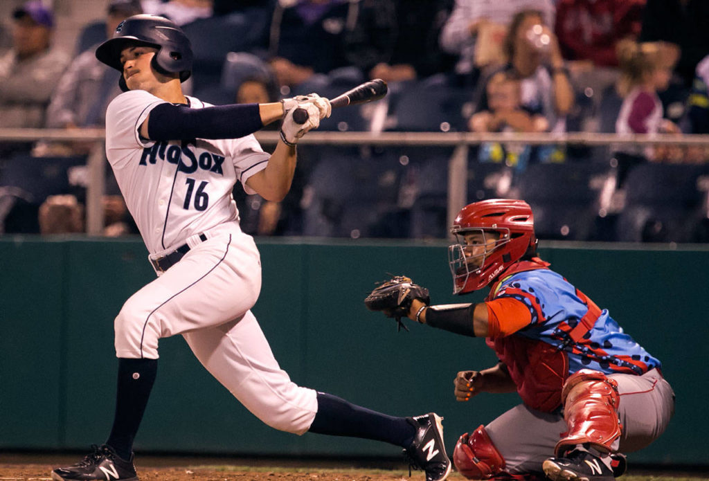 The AquaSox’s Ryne Ogren swings and misses with Spokane’s Fransisco Ventura catching during Game 1 of the Northwest League North Division Championship Series on Sept. 5, 2018, at Everett Memorial Stadium . (Kevin Clark / The Herald)
