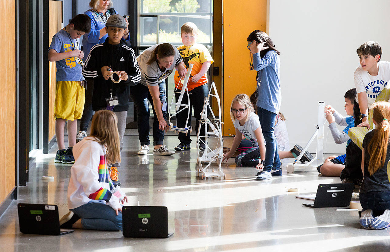 Fifth-grade students from Marshall Elementary in Marysville build test and remodel gravity cars, as part of a one week engineering program, in a hall at the University of Washington on Wednesday, Sept. 12, 2018 in Seattle, Wa. (Andy Bronson / The Herald)