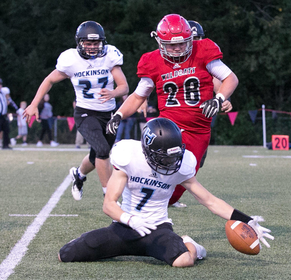 Hockinson’s Nick Charles (bottom) works to gather a blocked punt with Archbishop Murphy’s Evan Thode (28) trailing during a game on Sept. 6, 2018, at Archbishop Murphy High School in Everett. (Kevin Clark / The Herald)
