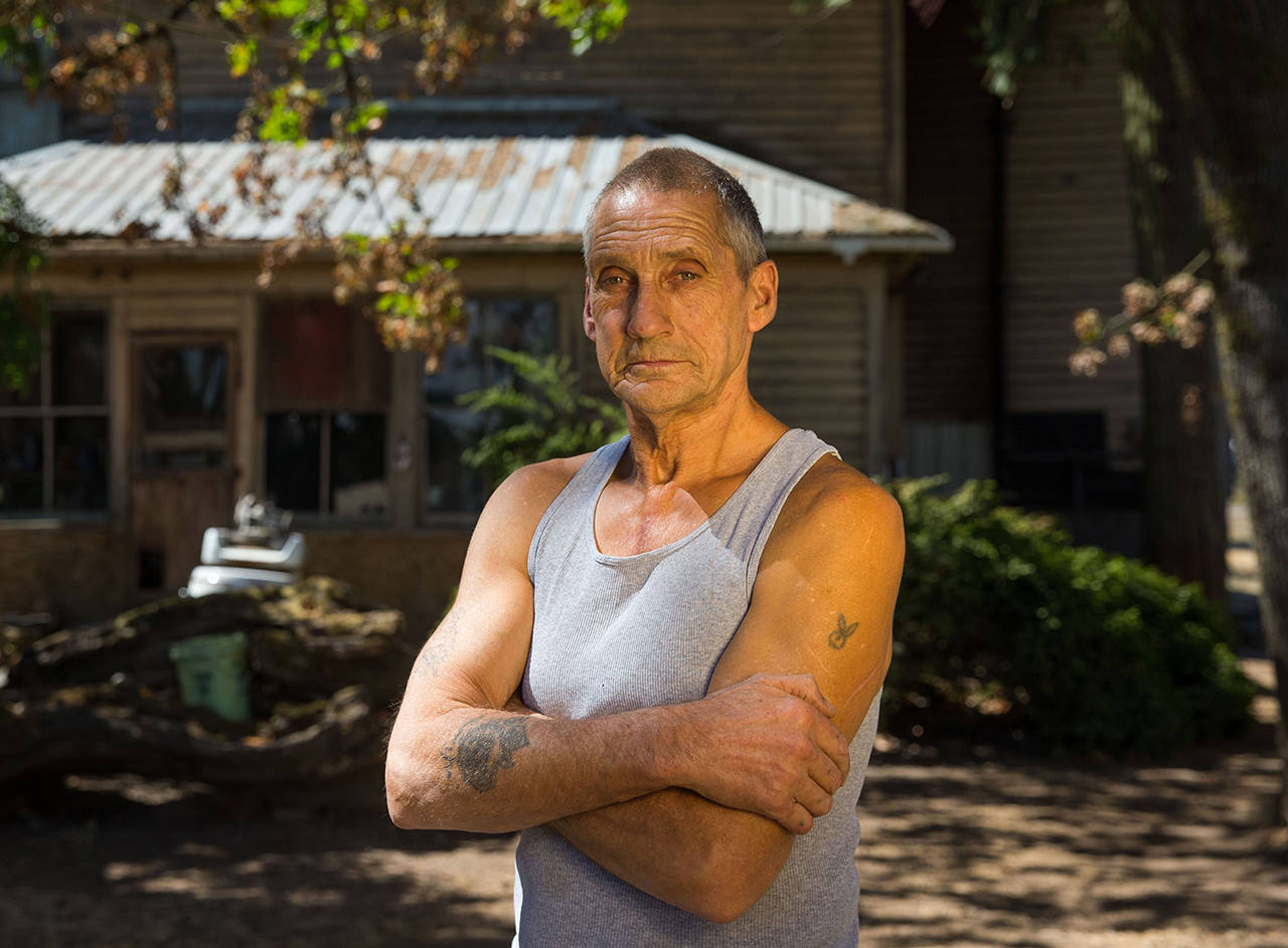 In this Aug 28 photo, filbert farmer Wayne Wise poses in Eugene, Oregon. Wise was mowing in his filbert orchard on July 15, when a piece of barbed wire was shredded by his mulcher, sending a piece of shrapnel into his side. He worked another half hour until his shirt soaked through with blood. (Brian Davies/The Register-Guard via AP)