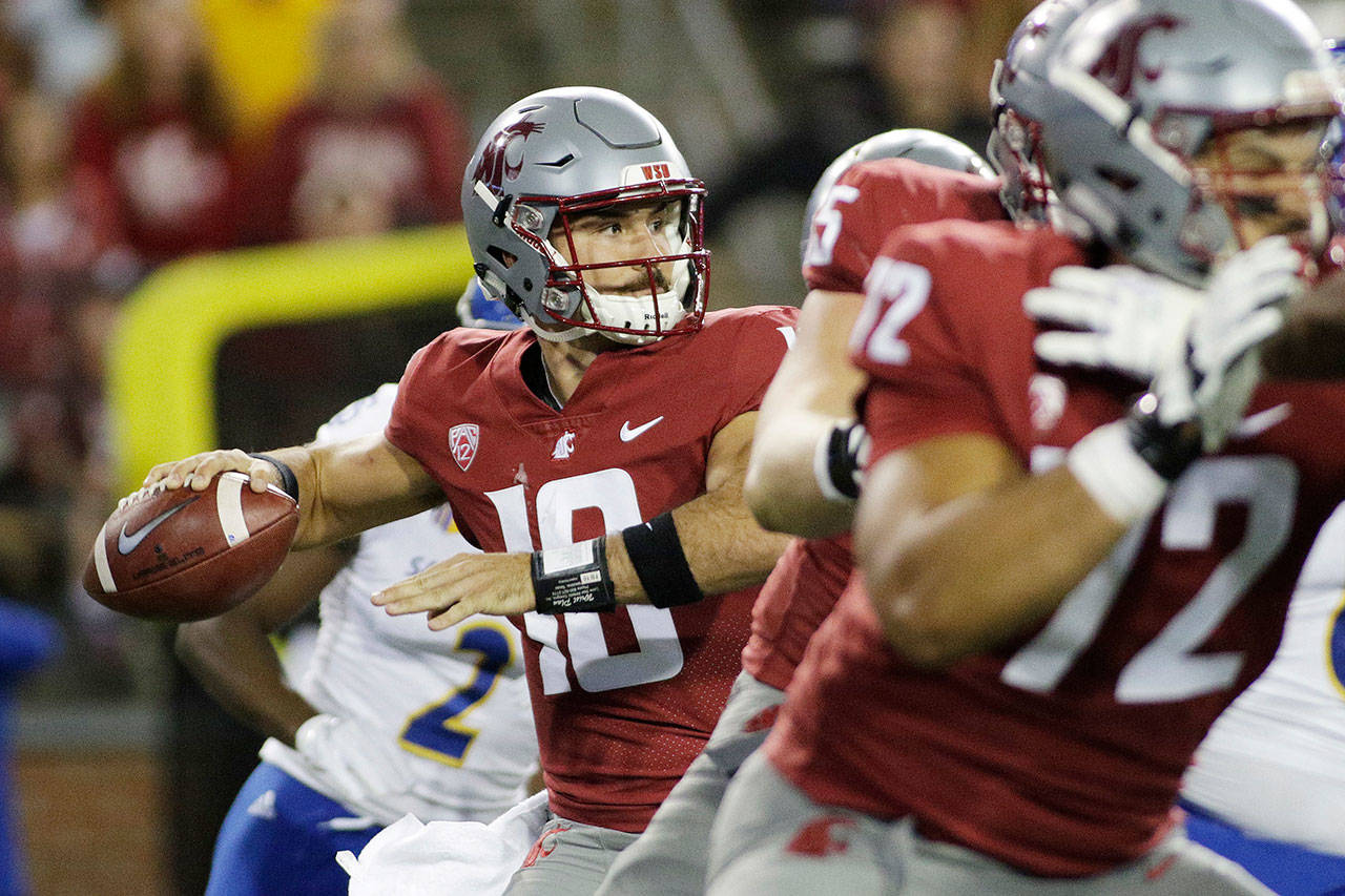 Washington State quarterback Gardner Minshew II (left) looks to pass during the first half of a game against San Jose State on Sept. 8, 2018, in Pullman. (AP Photo/Young Kwak)