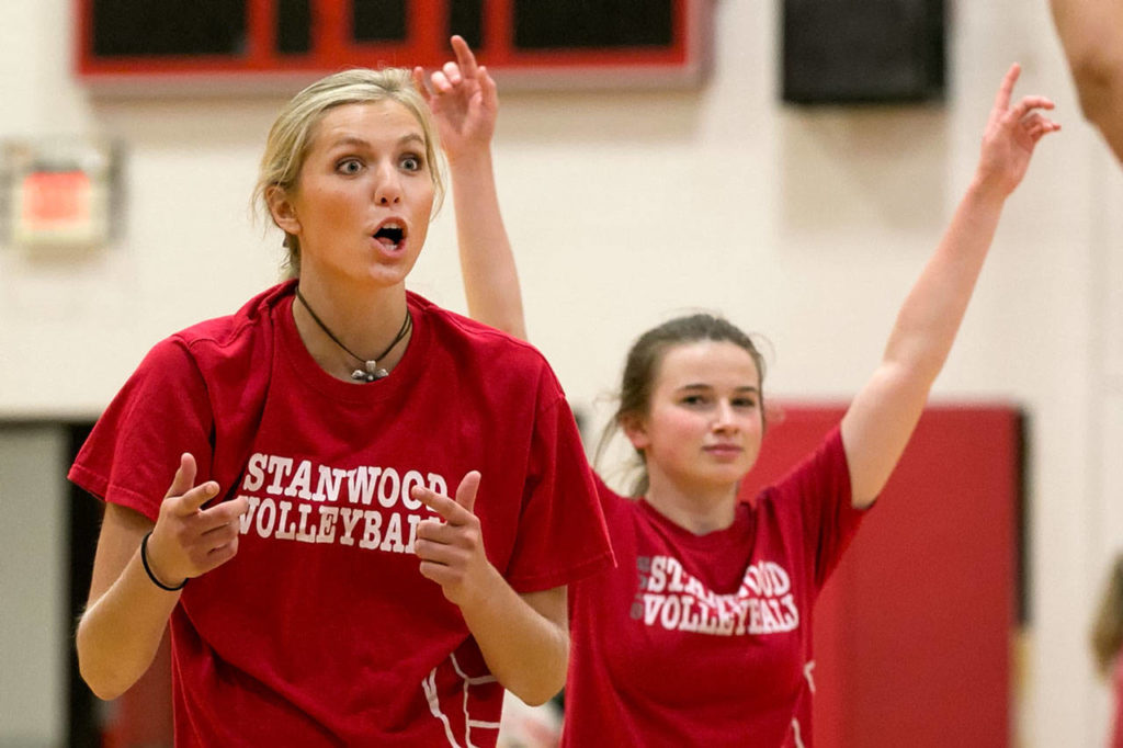 Stanwood’s Devon Martinka (left) and Veaya Carter react to a point during practice on Sept. 12, 2018, at Stanwood High School. (Kevin Clark / The Herald)
