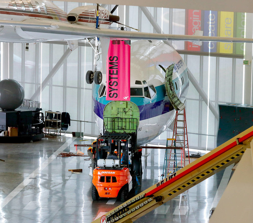 Workers this week prepare to move the nose section of a Boeing 727 with a forklift at the Future of Flight Aviation Center in Mukilteo. (Contributed photo)
