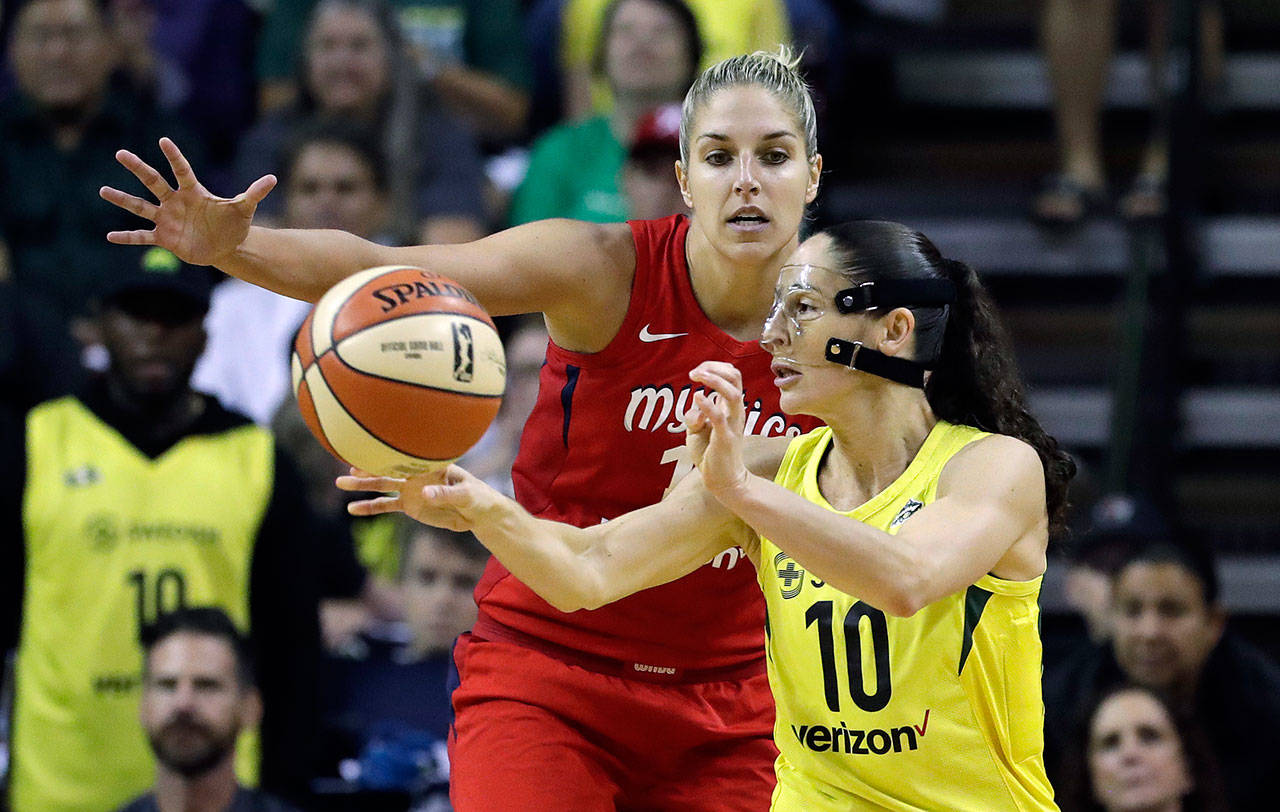 The Storm’s Sue Bird (10) passes in front of the Mystics’ Elena Delle Donne in the second half of Game 2 of the WNBA finals on Sept. 9, 2018, in Seattle. The Storm won 75-73. (AP Photo/Elaine Thompson)