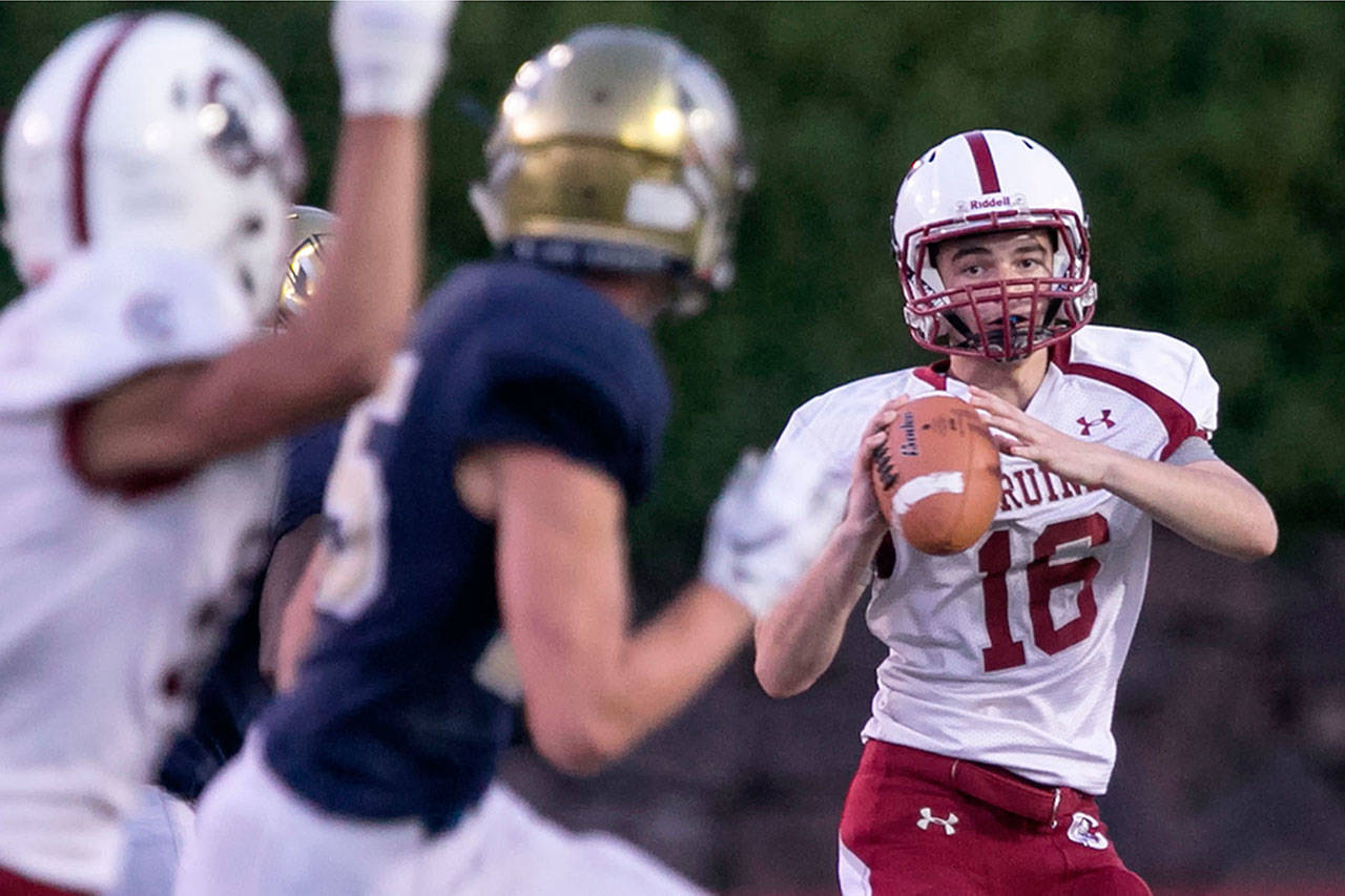 Cascade quarterback Noah Schmid looks for an open receiver during a game against Everett on Aug. 31 at Everett Memorial Stadium. (Kevin Clark / The Herald)