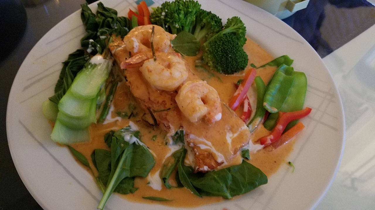 Salmon panang, topped with shrimp and a panang curry sauce and served with wilted spinach and and bell pepper, snow peas and broccoli. (Sharon Salyer / The Herald)