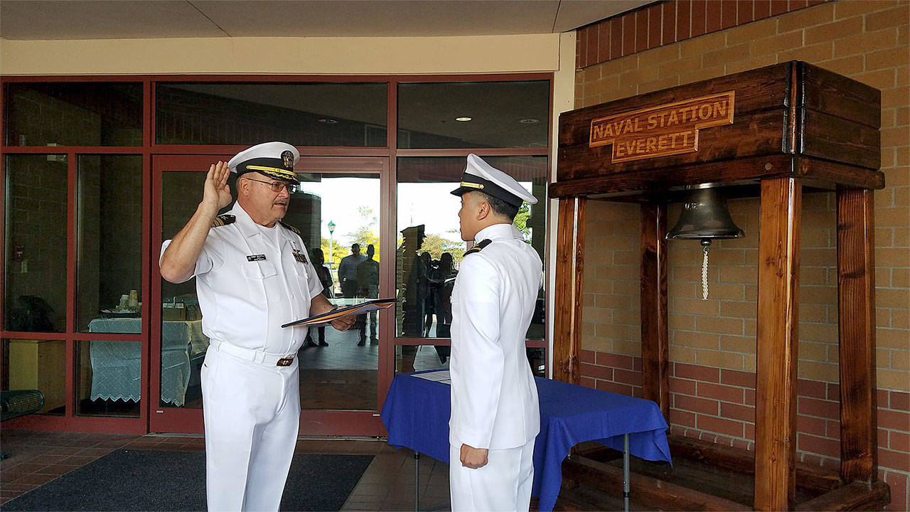 Leighton Flores, of Marysville, accepts his commissioning to the rank of ensign in the U.S. Navy from his former Marysville Navy Junior ROTC senior naval science instructor, retired Commander Randolph Brasfield, at a ceremony held Sept. 9 at Naval Station Everett. (Contributed photo)