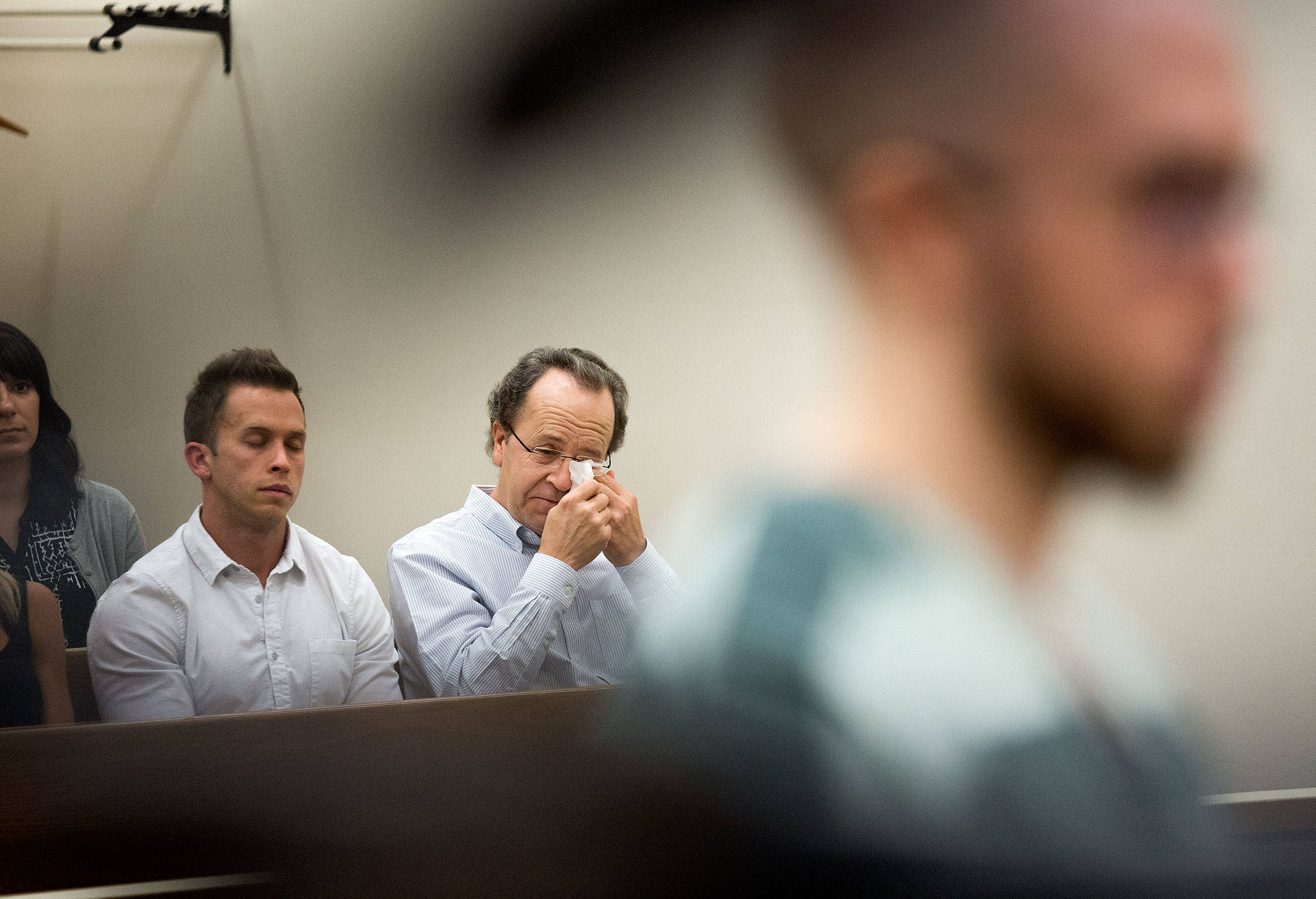 Alex (left) and Michael Konicke react as Zachary Konicke, who killed Michael’s wife and tried to kill Michael, is sentenced Thursday at the Snohomish County Courthouse in Everett. Zachary Konicke was given the maximum allowable sentence of 23 years for murder in the second degree, assault in the second degree and arson. (Andy Bronson / The Herald)