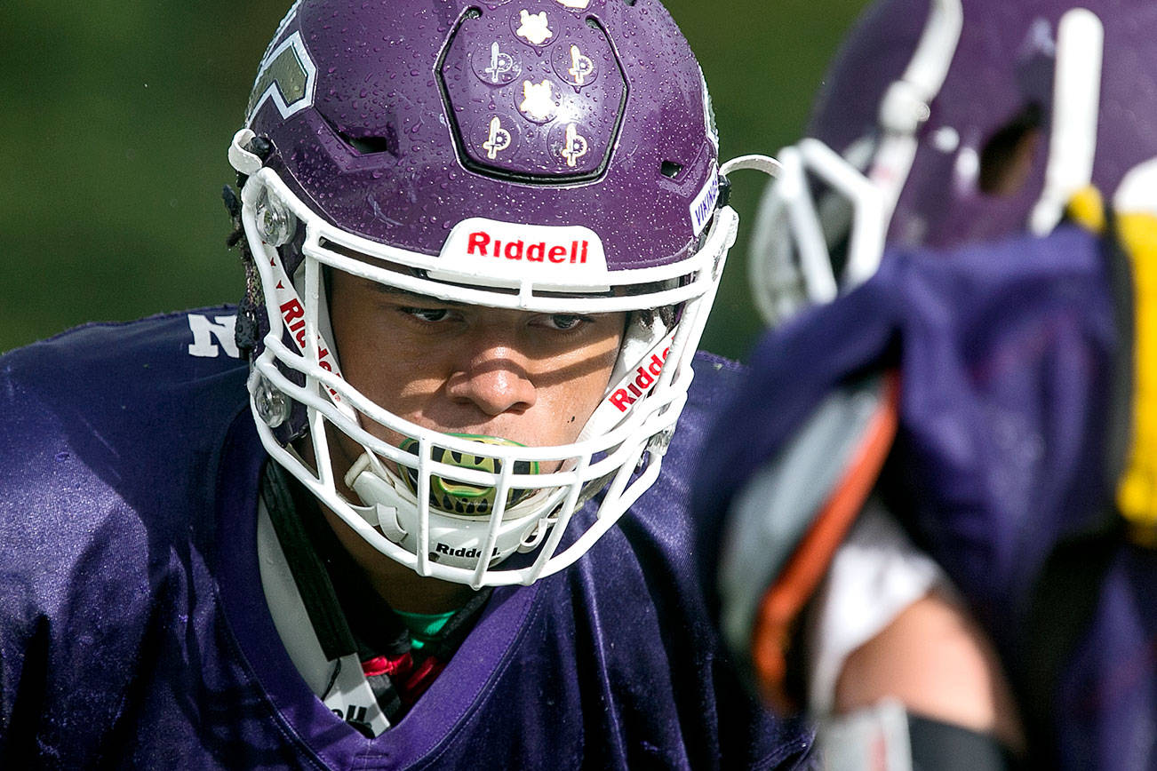 Lake Stevens’ Kasen Kinchen eyes his teammate on the line of scrimmage during practice Thursday afternoon in Lake Stevens on September 13, 2018. (Kevin Clark / The Herald)