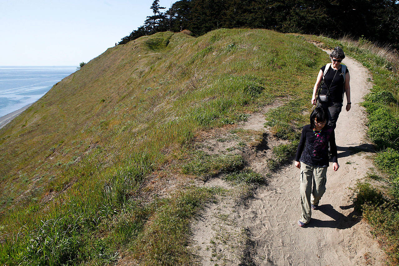 Tammy Deroche and Mia Ryan (front) of Sammamish, walk along the Bluff Trail at Ebey’s Landing in April of 2015. Ebey’s Landing Historical Reserve is one of many parks in Washington state that have received funding through the federal Land and Water Conservation Fund. (Ian Terry / Herald file photo)