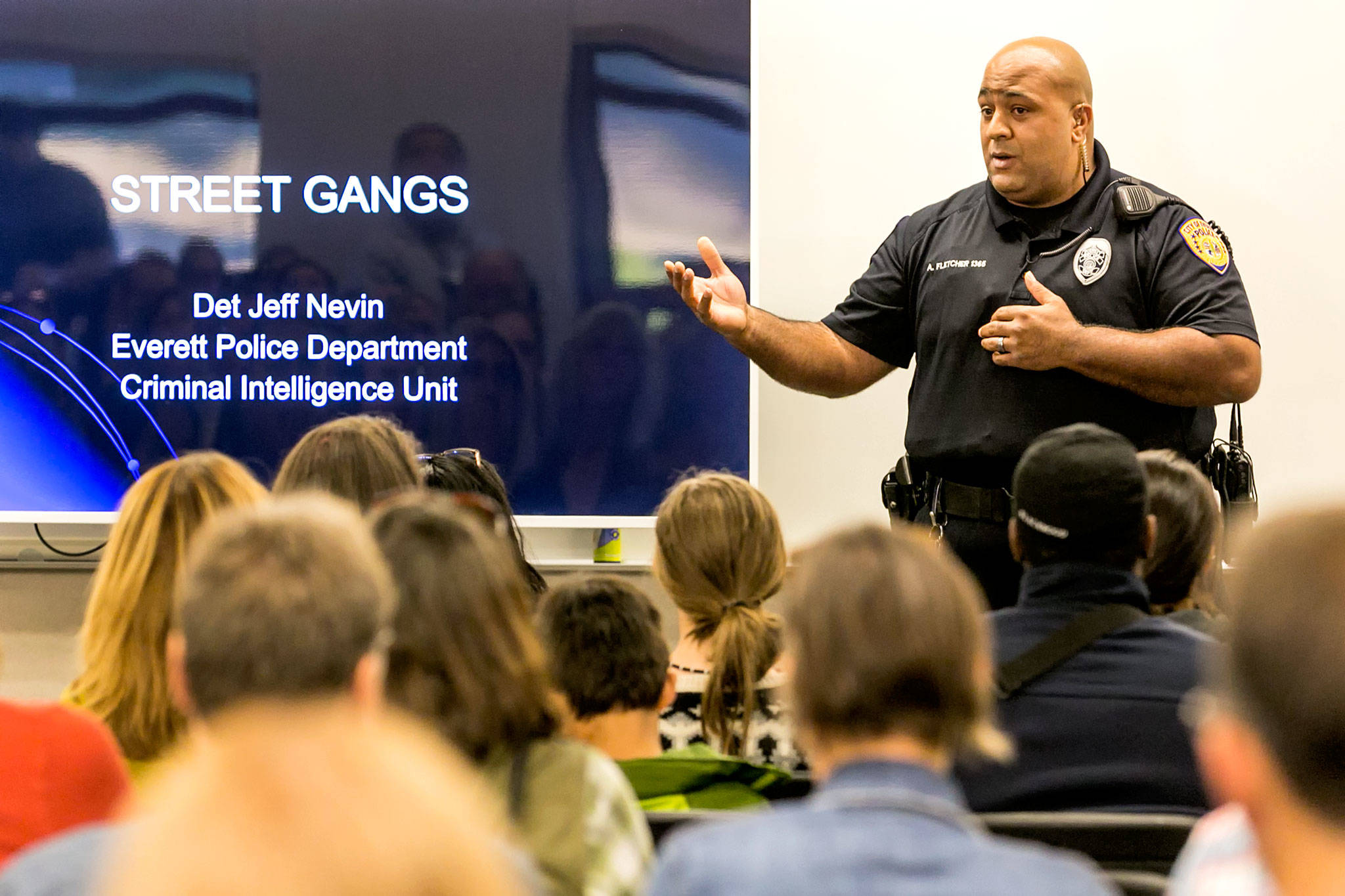 Officer Anthony Fletcher addresses the audience Monday night at Explorer Middle School in Everett. (Kevin Clark / The Herald)