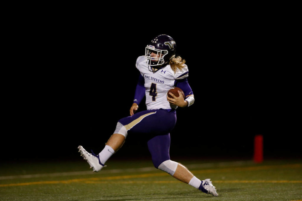 Lake Stevens quarterback Tre Long stretches for a touchdown late in the second quarter of Friday night’s game against Monroe. (Andy Bronson / The Herald)
