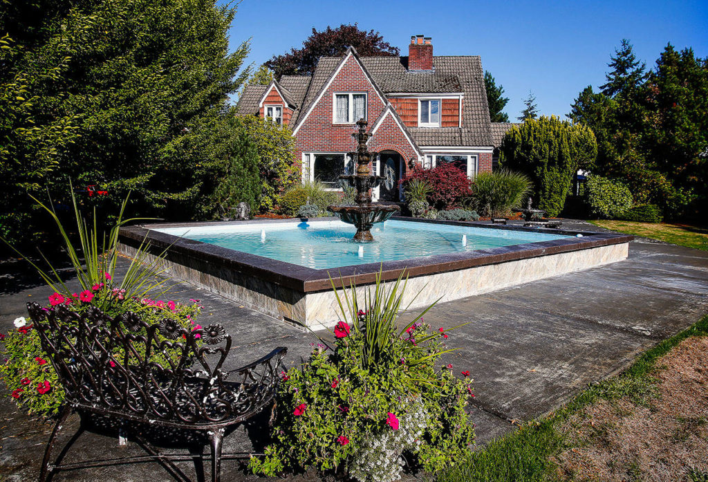 A fountain and pool have greeted guests at the gated Leifer Manor wedding venue along State Avenue in Marysville. Donna Leifer’s parents, Clarence and Vina Leifer, once operated a 300-acre strawberry farm north of Marysville. They built the house , later Leifer Manor, in 1948. (Dan Bates / The Herald)
