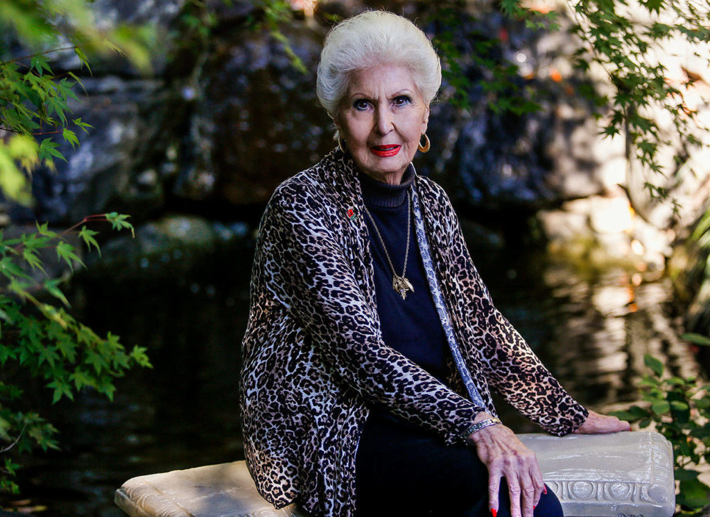 Donna Leifer, 88, sits near a waterfall where many a bride has posed for photos on her wedding day. Her own back yard became the Leifer Manor wedding venue 27 years ago. (Dan Bates / The Herald)

