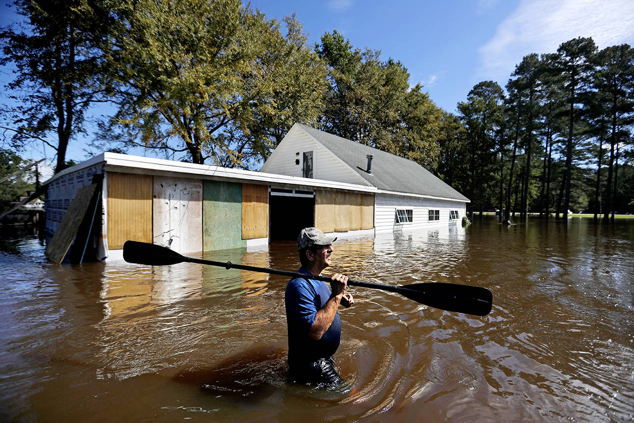 Kenny Babb retrieves a paddle that floated away on his flooded property as the Little River continues to rise in the aftermath of Hurricane Florence in Linden, North Carolina, on Tuesday. (AP Photo/David Goldman)