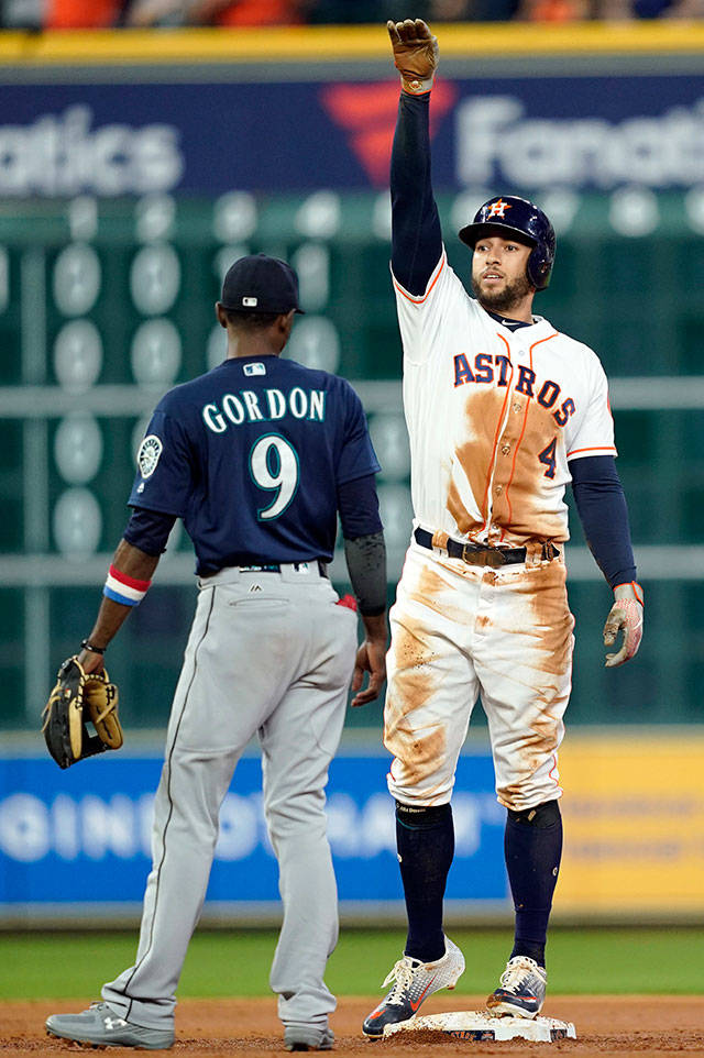 The Astros’ George Springer (4) celebrates after a run-scoring single as Mariners second baseman Dee Gordon (9) watches during the third inning of a game Sept. 18, 2018, in Houston. (AP Photo/David J. Phillip)
