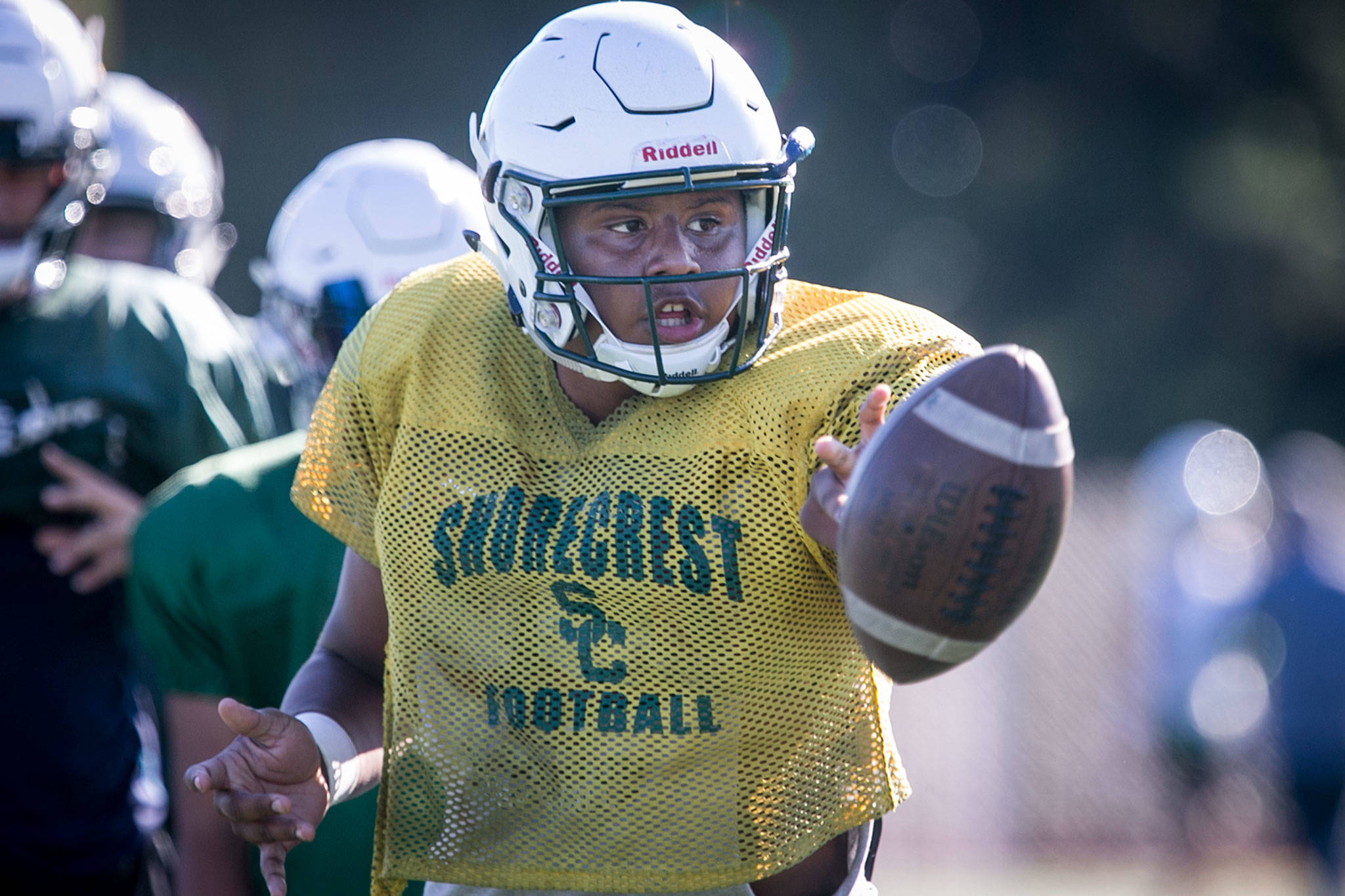 Shorecrest quarterback Eladio Fountain tosses a shovel pass during practice Wednesday afternoon at Shorecrest High School in Shoreline. The Scots are off to their first 3-0 start since 2005. (Kevin Clark / The Herald)