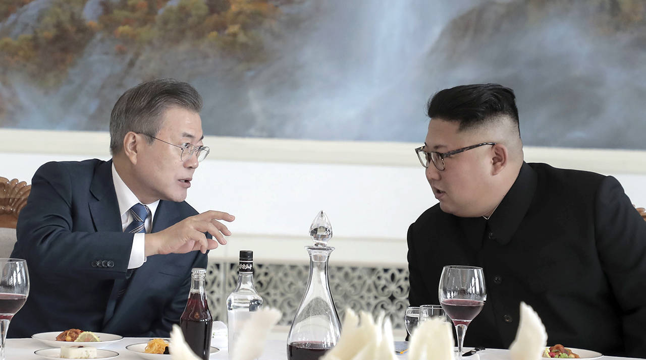 South Korean President Moon Jae-in (left) talks with North Korean leader Kim Jong Un at Okryu-Gwan restaurant in Pyongyang, North Korea, on Wednesday, Sept. 19. (Pyongyang Press Corps Pool via AP)