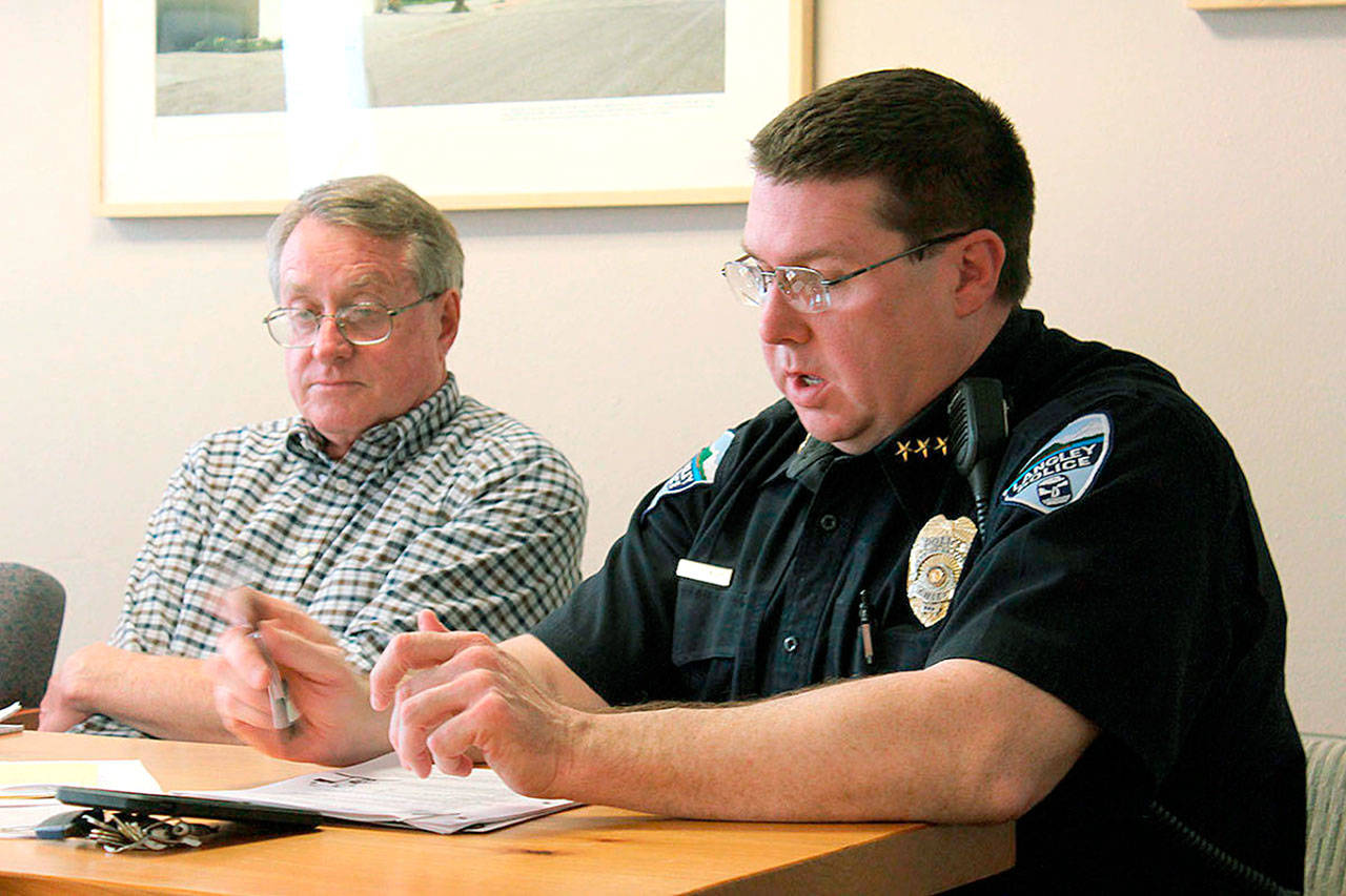 Then-Police Chief David Marks (right) speaks at a Langley City Council meeting on May 22. (Patricia Guthrie / South Whidbey Record file)