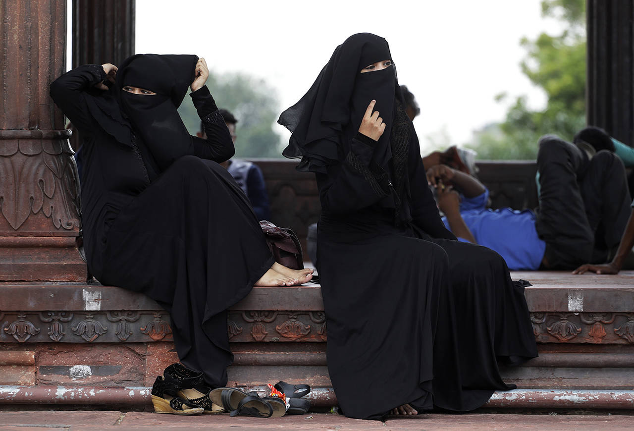 In this 2017 photo, Indian Muslim women rest inside Jama Masjid mosque in New Delhi, India. India’s government on Wednesday approved an ordinance to implement a top court ruling striking down the Muslim practice that allows men to instantly divorce. (AP Photo/Tsering Topgyal, File)