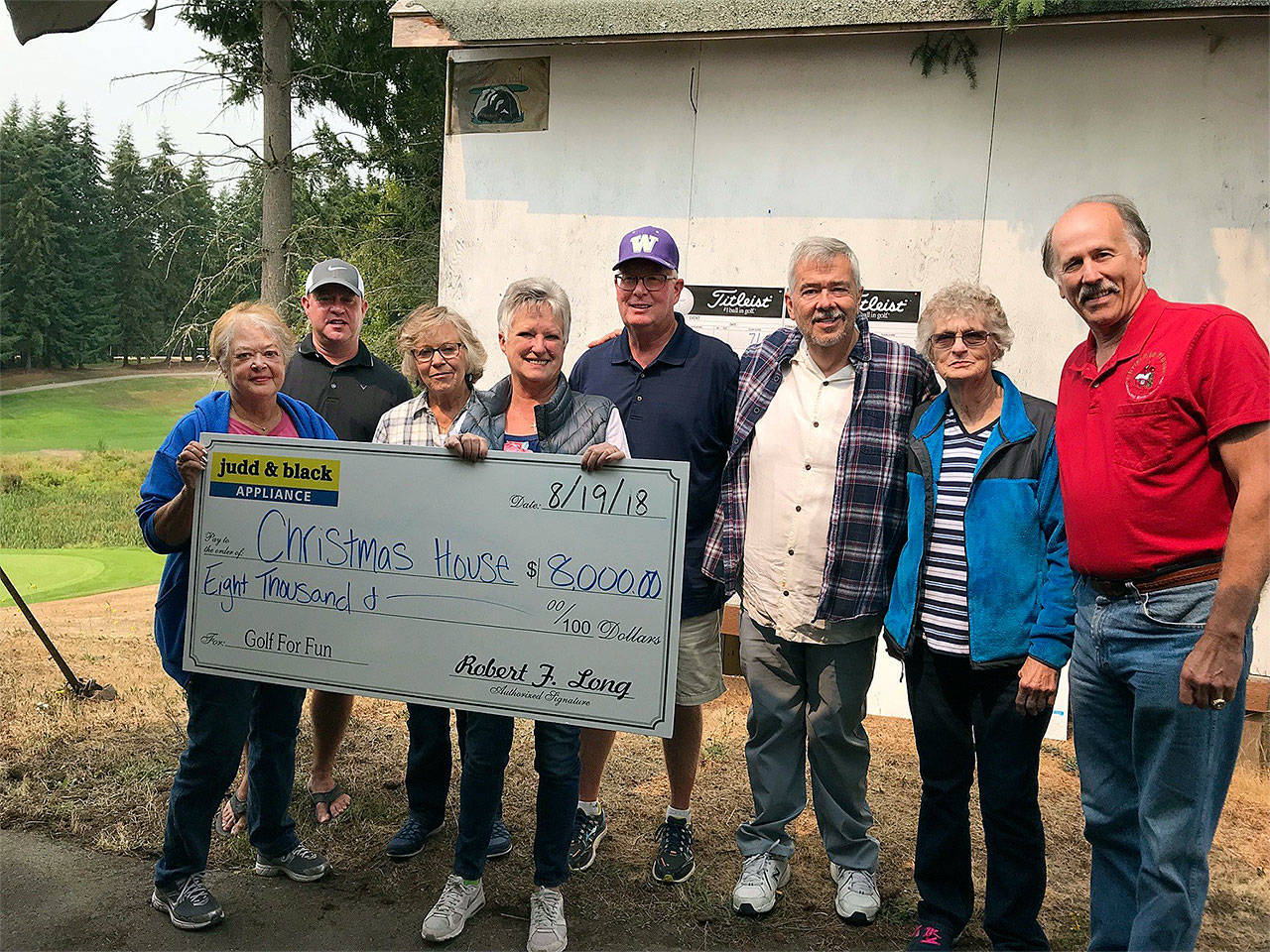 Cory Long of Judd & Black presents an $8,000 check to Christmas House board members at the conclusion of the company’s annual charity golf tournament at Battle Creek Golf Course. From left are Lynn Luscher, Long, Charilie Wood, Jenall Brister, Larry Lark, Barry Kinyon, Sylvia May and Gregg Milne. (Contributed photo)