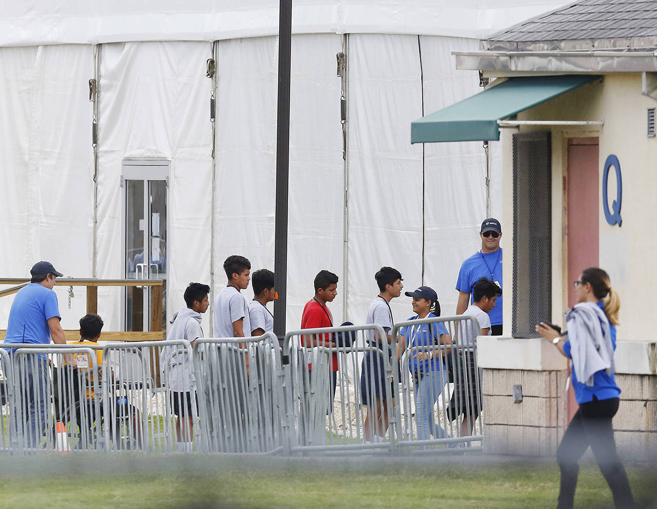 In this June 20 photo, immigrant children walk in a line outside the Homestead Temporary Shelter for Unaccompanied Children a former Job Corps site that now houses them in Homestead, Florida. (AP Photo/Brynn Anderson, File)