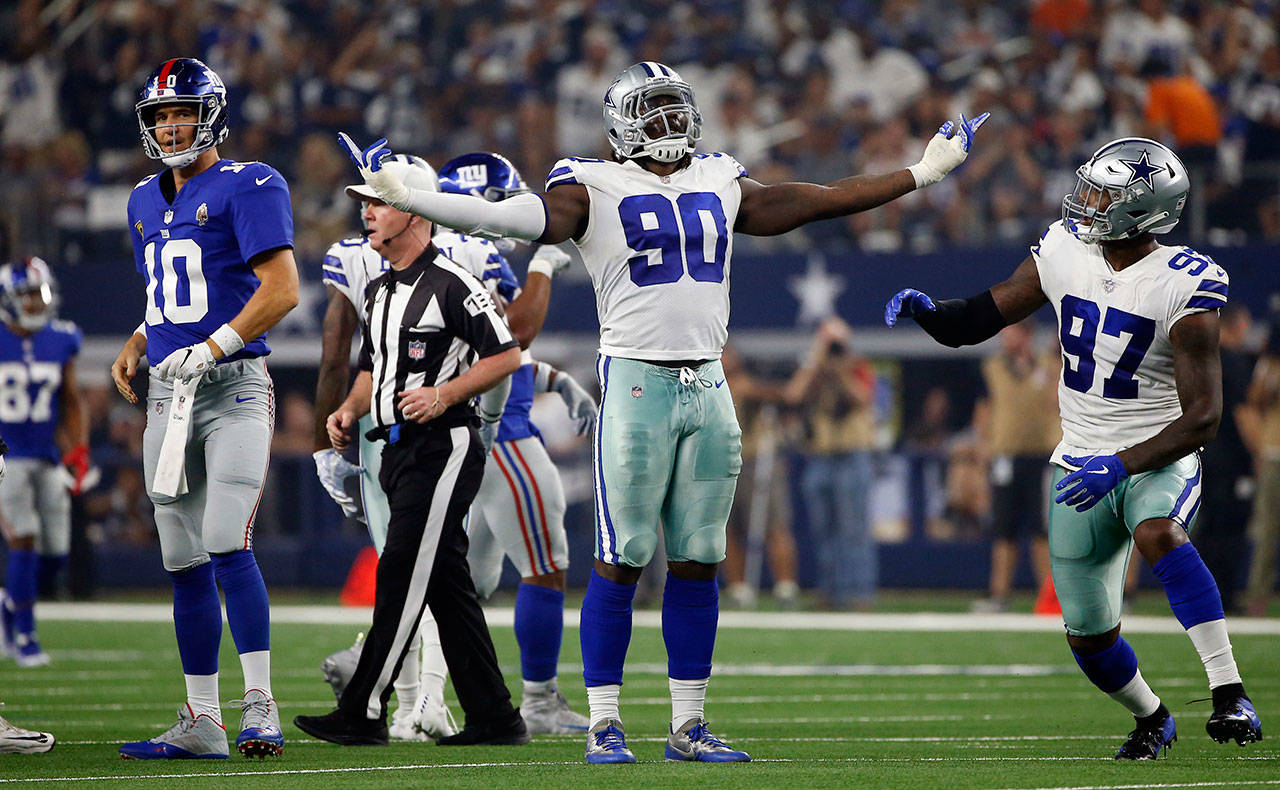 Cowboys defensive end Demarcus Lawrence (90) celebrates after sacking Giants quarterback Eli Manning (10) during the first half of a game on Sept. 16, 2018, in Arlington, Texas. (AP Photo/Ron Jenkins)