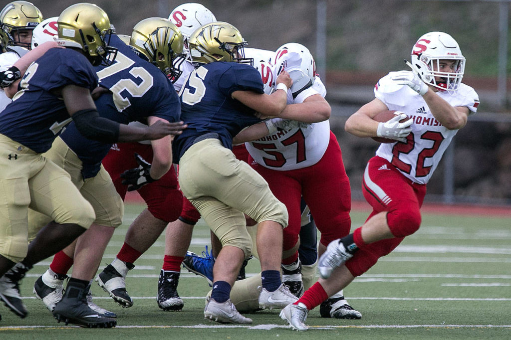 Snohomish running back Tyler Larson breaks through the scrum during a game against Everett on Sept. 21, 2018, at Everett Memorial Stadium. (Kevin Clark / The Herald)
