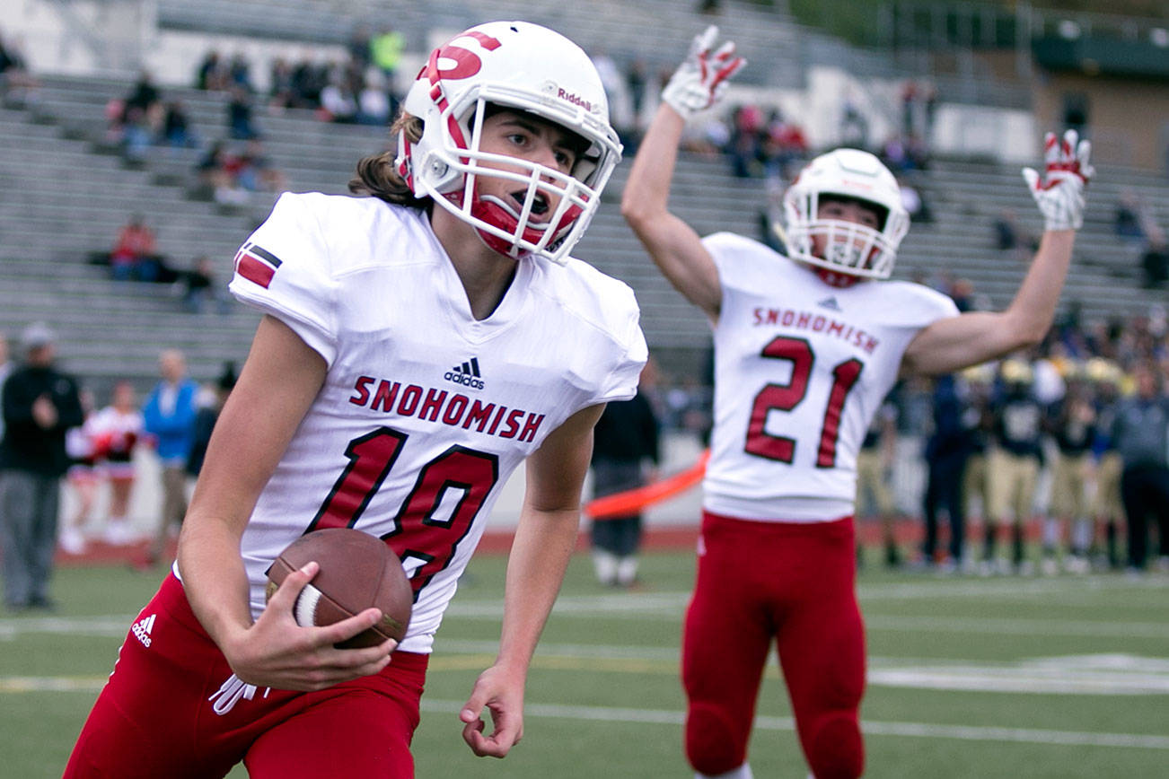 Snohomish’s Tayte Conover crosses the goal line with Snohomish’s Tyler Massena celebrating Friday night at Everett Memorial Stadium in Everett on September 21, 2018. (Kevin Clark / The Herald)
