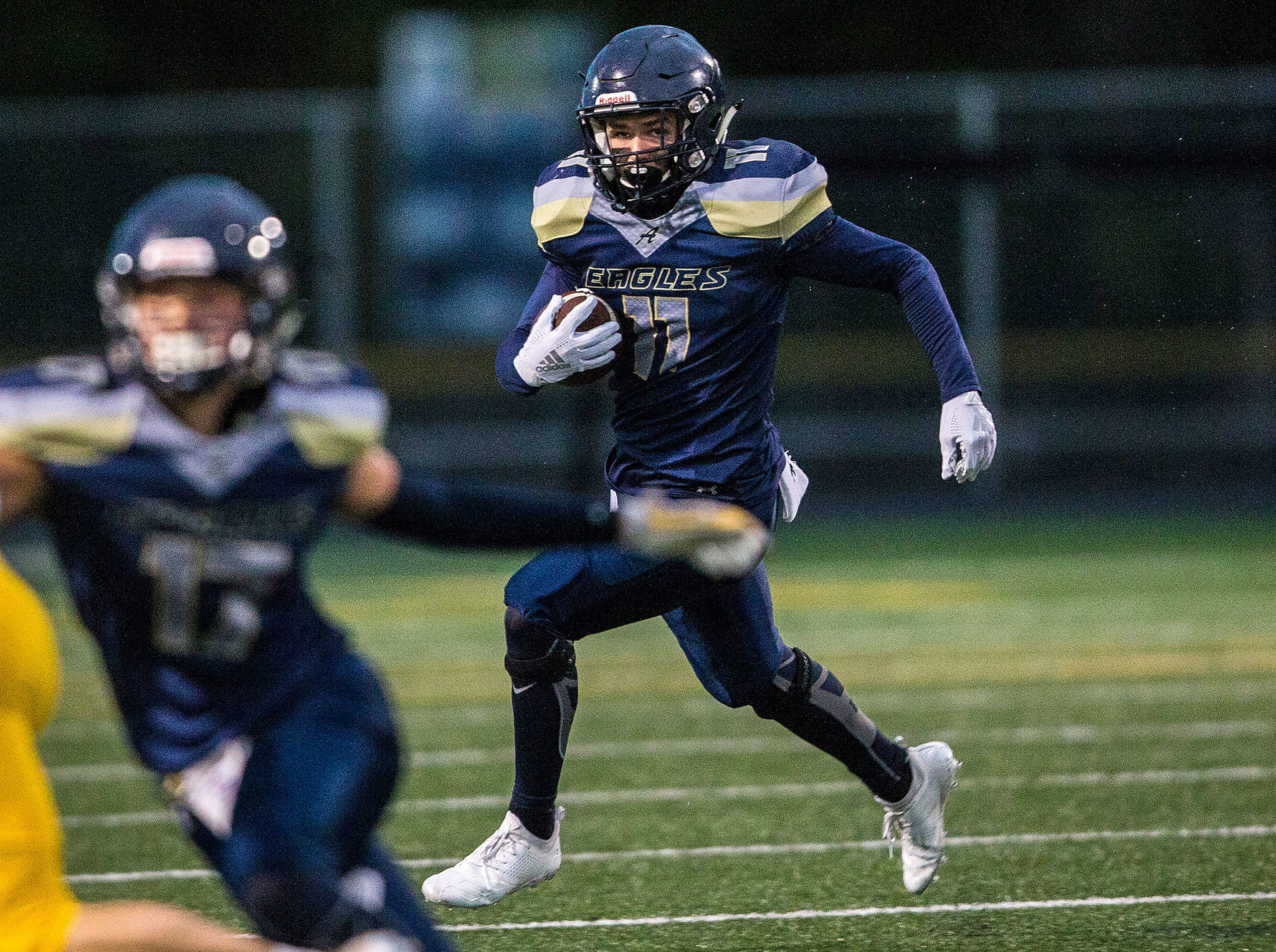 Arlington’s Daylin Pierce carries the ball during a game against Ferndale on Sept. 21, 2018, in Arlington. (Olivia Vanni / The Herald)