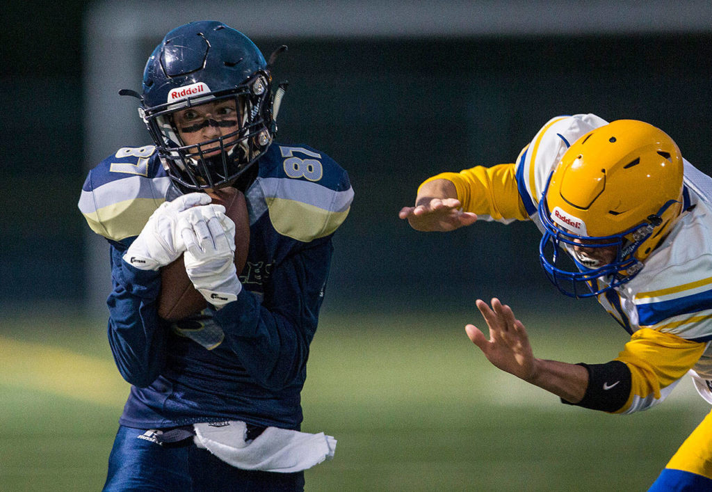 Arlington’s Dylan Simmons catches a pass during a game against Ferndale on Sept. 21, 2018, in Arlington. (Olivia Vanni / The Herald)
