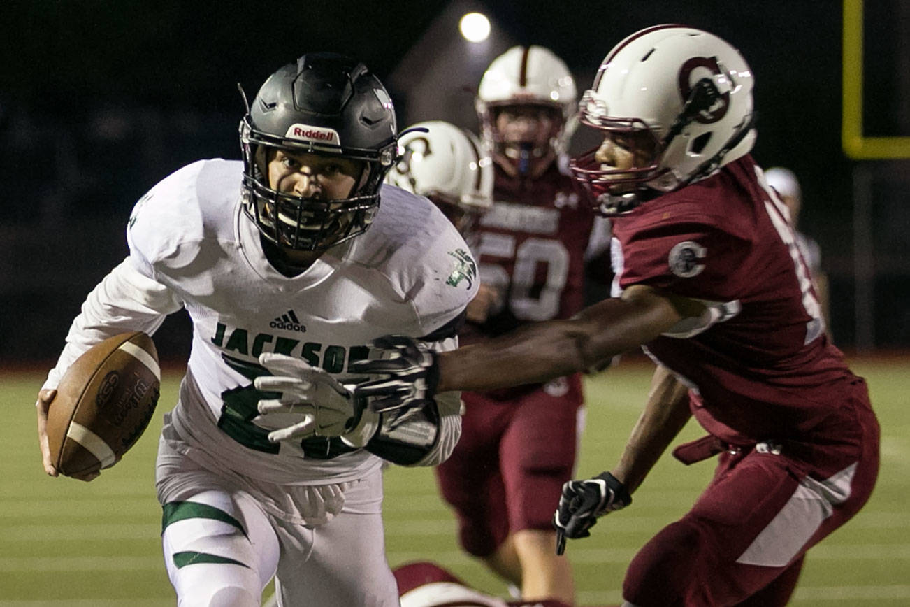 Jackson’s Nick Walsh rushes for the goal line with Cascade’s Amir Andrews (right) trailing at Everett Memorial Stadium. (Kevin Clark / The Herald)