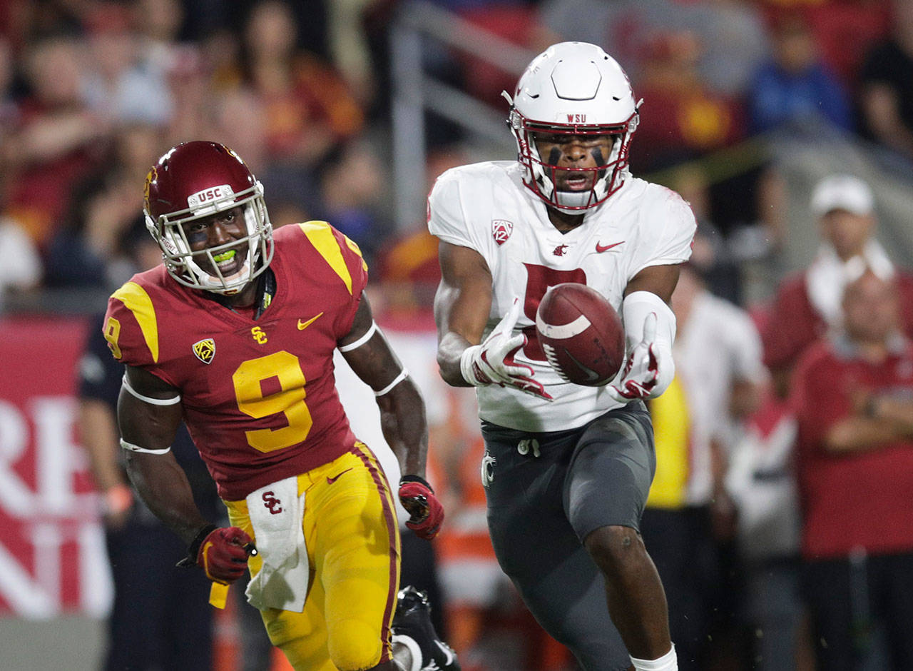 Washington State wide receiver Easop Winston (right) makes a catch next to Southern California cornerback Greg Johnson during the first half of a game on Sept. 21, 2018, in Los Angeles. (AP Photo/Jae C. Hong)