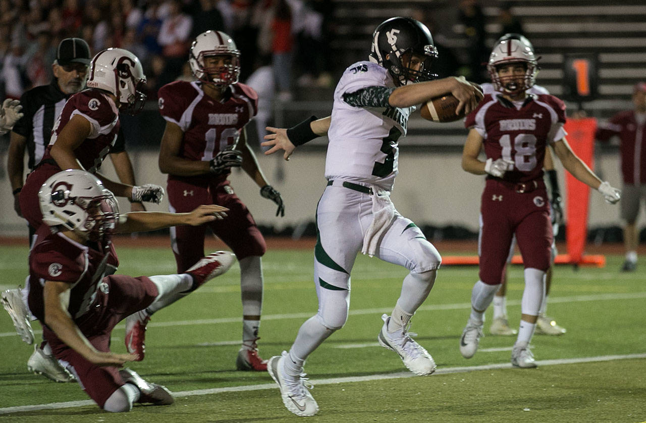 Jackson’s Ben Olesen stretches acrosses the goal line with Cascade’s defense looking on Friday night at Everett Memorial Stadium. (Kevin Clark / The Herald)