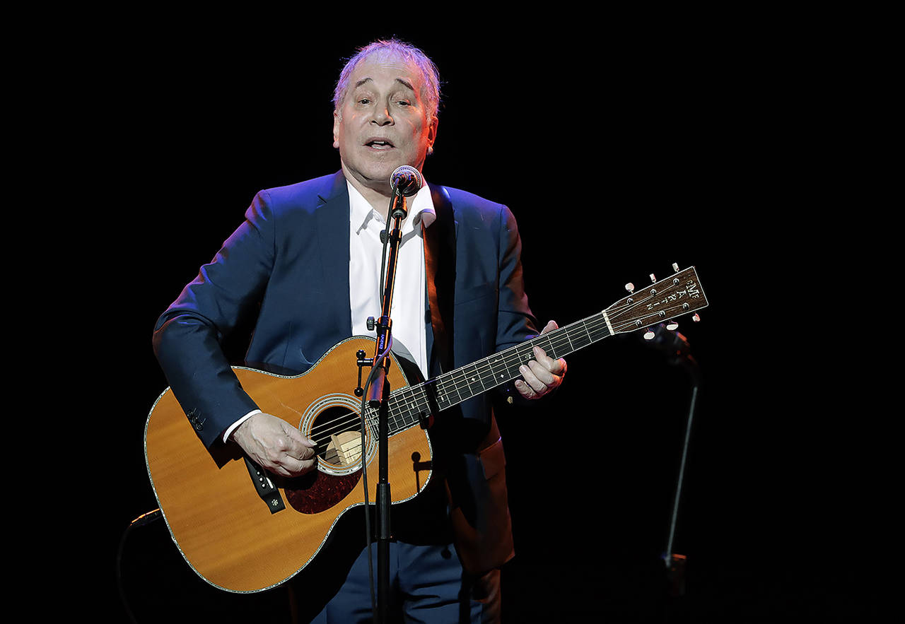 In a 2016 photo, musician Paul Simon performs during the Global Citizen Festival in New York. Simon wraps up his farewell concert tour Saturday at a park in Queens, a bicycle ride across the borough from where he grew up. The 76-year-old singer picked Flushing Meadows Corona Park to say goodbye, an outdoor show on the first night of autumn. (AP Photo/Julie Jacobson, File)
