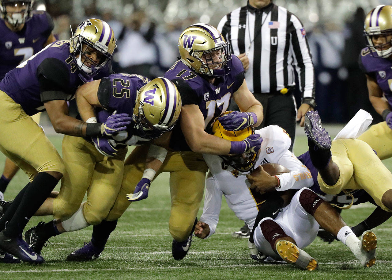 Arizona State quarterback Manny Wilkins is wrapped up by Washington linebacker Tevis Bartlett (17) on a keeper play during the first half of a game on Sept. 22, 2018, in Seattle. (AP Photo/Ted S. Warren)