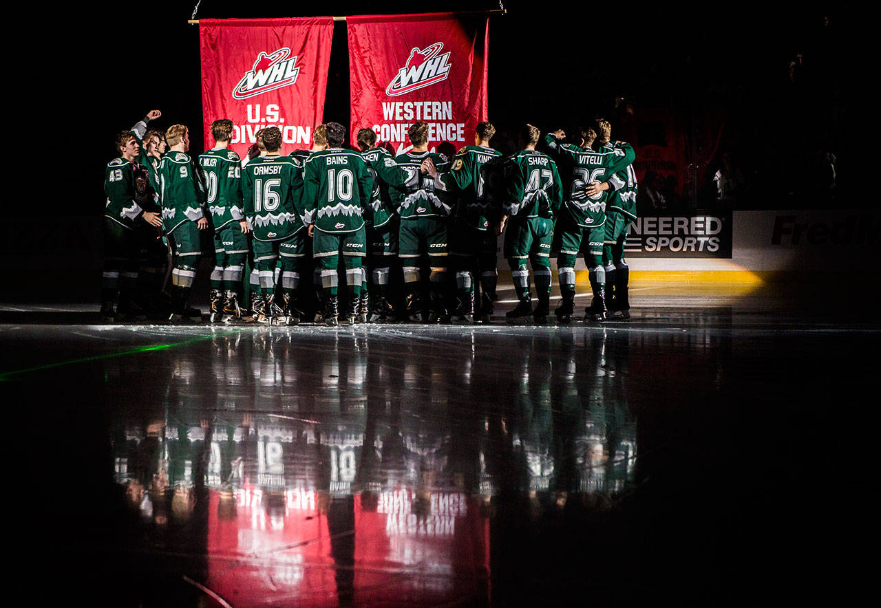 The Silvertips players that were a part of the conference and division winning team gather on the ice to raise their banners before the game against the Vancouver Giants on Sept. 22, 2018 in Everett, Wa. (Olivia Vanni / The Herald)